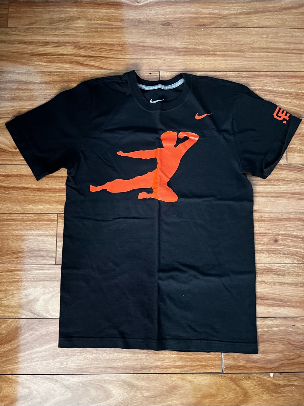 Nike Black Tee with Bright Orange Graphic and White Swoosh